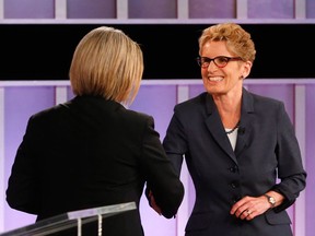 Ontario Liberal Party leader Kathleen Wynne (right) shakes hands with Ontario NDP leader Andrea Horwath after the televised debate on June 3, 2014. (Mark Blinch / The Canadian Press)