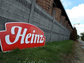 A Heinz sign, removed from the plants, rests on the ground near the pickle tanks at the Heinz plant in Leamington on Thursday, June 26, 2014. After over a century of business in the town the factory will close this Friday.       (Tyler Brownbridge/The Windsor Star)