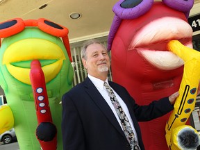 Downtown Windsor BIA chair Larry Horwitz with a couple of Balloonapalooza's inflatable characters on June 5, 2014. (Tyler Brownbridge / The Windsor Star)