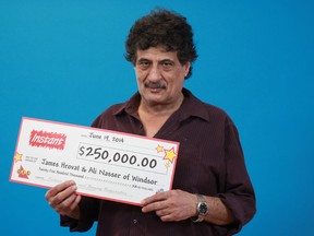 Windsor resident James Hrovat holds the prize cheque that he and Ali Nasser won from playing a Turbo Cash Instant Game. The odds of getting the $250,000 jackpot are one in 476,000. Photographed at the OLG Prize Centre in Toronto. (Handout / The Windsor Star)