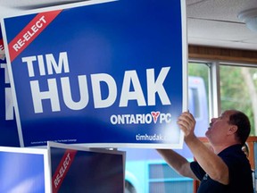 An Ontario PC organizer prepares signage for the headquarters of Tim Hudak at the Mountain Ridge Community Centre in Grimsby Ont., prior to election evening results, Thursday June 12, 2014.  (Peter J. Thompson/National Post)