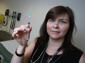 Registered nurse, Nicole Dube, holds a needle carrying Invega Sustenna, a long-acting anti-psychotic drug, at the Wellness Injection Clinic at Hotel-Dieu Grace Health Care, Friday, June 20, 2014.  (DAX MELMER/The Windsor Star)