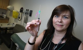 Registered nurse, Nicole Dube, holds a needle carrying Invega Sustenna, a long-acting anti-psychotic drug, at the Wellness Injection Clinic at Hotel-Dieu Grace Health Care, Friday, June 20, 2014.  (DAX MELMER/The Windsor Star)