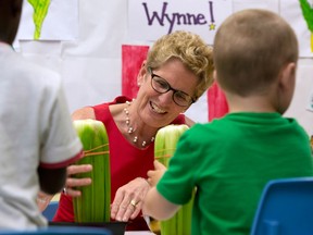 Ontario Liberal Leader Kathleen Wynne paints with vegetables during a campaign stop at a school in Trenton, Ontario on Tuesday June 10, 2014, 2014. THE CANADIAN PRESS/Frank Gunn