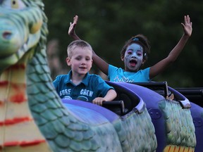 Chase Gray, 4, left, and Inaya St. Fleur, 6, ride the children's roller coaster at the LaSalle Strawberry Festival, Saturday, June 7, 2014.  (DAX MELMER/The Windsor Star)
