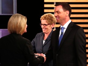 Ontario NDP leader Andrea Horwath, Ontario Premier Kathleen Wynne, centre, and Ontario Progressive Conservative leader Tim Hudak speak after taking part in the Ontario provincial leaders debate in Toronto, Tuesday June 3, 2014. (THE CANADIAN PRESS/Mark Blinch)