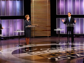 Ontario Premier and Ontario Liberal leader Kathleen Wynne, centre, Ontario NDP leader Andrea Horwath, left, and Ontario Progressive Conservative leader Tim Hudak take part in the Ontario provincial leaders debate in Toronto, Tuesday June 3, 2014. (THE CANADIAN PRESS/Mark Blinch)