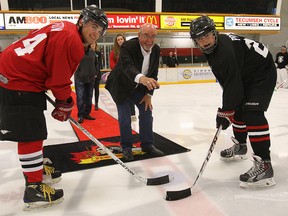 The inaugural Probert Classic hockey game was held Friday, June 6, 2014, at the Tecumseh Arena. Proceeds from the game support the upcoming annual Bob Probert Memorial Ride, which has raised more than $260,000 for cardiac care in Windsor-Essex. Tecumseh Mayor Gary McNamara drops the puck for Zach Rogow (L) and Jack Probert, the son of Bob Probert. (DAN JANISSE/The Windsor Star)