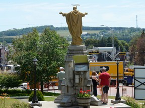 Locals gather at the entrance of the Sainte-Agnes Church to view the train derailment site Friday, July 12, 2013 in Lac-Megantic, Que.THE CANADIAN PRESS/Ryan Remiorz ORG XMIT: RYR208