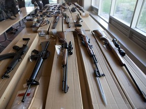 Seized firearms are displayed during a news conference to update the media about "Project Traveller" at 23 Division in Toronto on Friday, June 14, 2013. "Project Traveller" is a police operation that targeted gun and drug activity across southern Ontario and resulted in 43 arrests and the seizure of 40 firearms and thousands of dollars. (Matthew Sherwood for National Post)