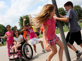 Notre Dame Catholic School students, from left to right, Rocio, Angelina, Vienna, Kristian and Lily, play outside during one of the last recesses of the year, Thursday, June 26, 2014, in the yard behind the school. Catholic school classes officially end June 27. (RICK DAWES/The Windsor Star)