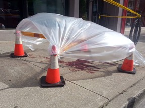 Ontario Provincial Police are investigating after a large amount of blood was discovered on the sidewalks along Talbot Street West on Friday, June 13, 2014. (TYLER JONES/Special To The Star)