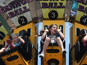 Faith Fitzgerald, 12, centre, screams as she rides the Cannon Ball with her sister, Jada Fitzgerald, 11, right, at Summer Fest, Saturday, June 28, 2014. (DAX MELMER/The Windsor Star)