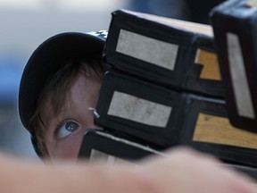 Stone Belanger, 6, keeps his focus while being an assistant for Cobbler Jay, a busker, at Summer Fest, Saturday, June 28, 2014. (DAX MELMER/The Windsor Star)