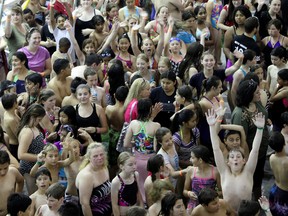 Swimmers gather for a group photo Friday, June 20, 2014, at the Windsor International Aquatic and Training Centre. Over 1,000 people participated at the complex as part of the World's Largest Swimming Lesson, in an attempt to break Guinness records and to learn water safety. (RICK DAWES/The Windsor Star)