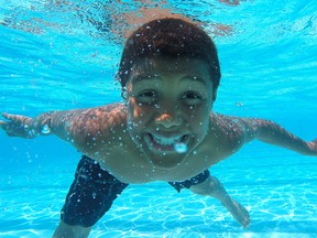 Tayshaun Jackson, 10, enjoys the water on the second day of summer at Lanspeary Pool, Sunday, June 22, 2014.  Sunday is the first day the public pools were open for summer.  (DAX MELMER/The Windsor Star)