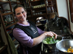 Havah Cleveland, 25, prepares a salad in the galley of the Peacemaker, a tall ship docked at Dieppe Park, Friday, June 20, 2014.  (DAX MELMER/The Windsor Star)