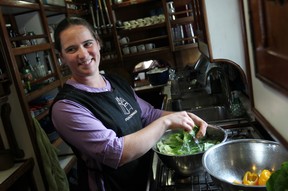 Havah Cleveland, 25, prepares a salad in the galley of the Peacemaker, a tall ship docked at Dieppe Park, Friday, June 20, 2014.  (DAX MELMER/The Windsor Star)