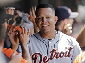 Tigers slugger Miguel Cabrera celebrates in the dugout after scoring on J.D. Martinez's two-run double in the fifth inning against the Cleveland Indians, Sunday, June 22, 2014, in Cleveland. (AP Photo/Mark Duncan)