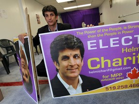 Helmi Charif holds ups a pair of election signs that were recent vandalized at his campaign office in Windsor on Wednesday, June 4, 2014.              (Tyler Brownbridge/The Windsor Star)