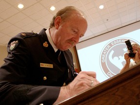 Insp. Glenn Miller of the Essex County OPP signs the Violent Threat Risk Assessment Protocol, June 3, at the GECDSB building at 451 Park St. W.. Educators, law enforcement, mental health services and community members officiated the protocol which aims to reduce violent behaviour among young people in the area. (RICK DAWES/The Windsor Star)