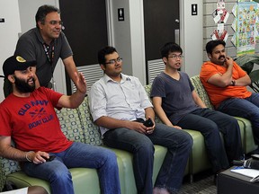 Navjot Sing (left) talks with Enrique Chacon as students take in the start of the World Cup at the International Student Centre at the University of Windsor on Thursday, June 12, 2014.               (Tyler Brownbridge/The Windsor Star)