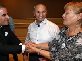 Tony Azar, centre, and his wife, Theresa Azar, receive congratulations from Msgr. Elie Zouein after announcing his intention to run for the position of deputy mayor of the Town of Tecumseh during event at Ciociaro Club on Monday. (NICK BRANCACCIO / The Windsor Star)