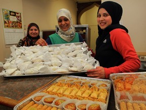 New Yasmeen Bakery workers Rochin Khalil, left, Najat Almousawi and Malak Bazzi show off traditional baklava and maamoul sweets. Bakeries and restaurants extend their hours during Ramadan to accommodate early and late dinners. (NICK BRANCACCIO / The Windsor Star)