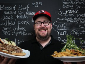 Mike Cowan, owner of The Carvery, displays a porchetta sandwich and a summer salad at his new restaurant at Wyandotte Street East and Hall Avenue. (DAX MELMER / The Windsor Star)