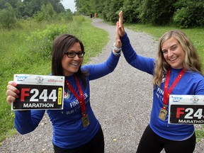 Great Wall of China marathon runners Nikki Leblanc, left, and Anissa Noakes completed the gruelling race in May. here, the runners celebrate their accomplishment this week at Oakwood Trail. (NICK BRANCACCIO / The Windsor Star)