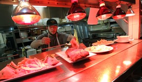 Tyler Seman serves up a plate of ribs at Tunnel Bar-B-Q in Windsor. (TYLER BROWNBRIDGE / The Windsor Star)