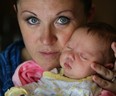 Katie Copus holds newborn Quinn Copus Latimer, July 7, 2014. Quinn was born June 20th at Windsor Regional Hospital and Katie and her family would like to thank the anonymous donor family who left a generous gift basket.  (NICK BRANCACCIO/The Windsor Star)