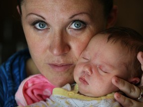Katie Copus holds newborn Quinn Copus Latimer, July 7, 2014. Quinn was born June 20th at Windsor Regional Hospital and Katie and her family would like to thank the anonymous donor family who left a generous gift basket.  (NICK BRANCACCIO/The Windsor Star)