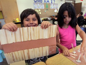In this file photo, First Nations summer students James Mitchell, 6, left, and Maria Novelo Emery, 6, work on their long house project during Camp Migizi at John Campbell School July 8, 2014. Camp Migizi is a summer learning program for local aboriginal students. (NICK BRANCACCIO/The Windsor Star)