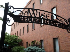 Welcome sign for Wiser's Reception Centre and Building 26, an office tower, behind right, Wednesday July 9, 2014. (NICK BRANCACCIO/The Windsor Star