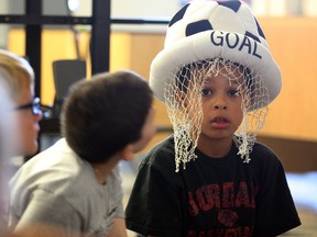 Summer Learning Program student Dominic McKesey, drews some stares while participating shared reading activity Thursday July 10, 2014. It was also Crazy Hat Day at the camp, located at Catholic School Board office on California Avenue. (NICK BRANCACCIO/The Windsor Star)