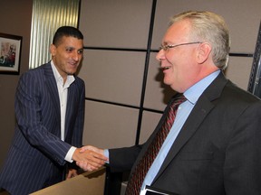 Robin Easterbrook, right, shakes the hand of Mayor Eddie Francis at City Hall where Easterbrok filed to become a candidate for mayor, Thursday July 10, 2014. (NICK BRANCACCIO/The Windsor Star)