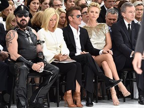 Peter Marino, left, Marie-Chantal of Greece, Sean Penn, Charlize Theron and Bernard Arnault attend the Christian Dior show as part of Paris Fashion Week - Haute Couture Fall 2014 on July 7, 2014 in Paris, France. (The Associated Press)