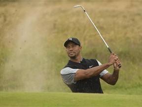 Tiger Woods plays a shot from the bunker near the 15th green during a practice round at Royal Liverpool Golf Club prior to the start of the British Open Golf Championship, in Hoylake, England, Saturday, July 12, 2014. The 2014 Open Championship starts on Thursday July 17. (AP/Jon Super)