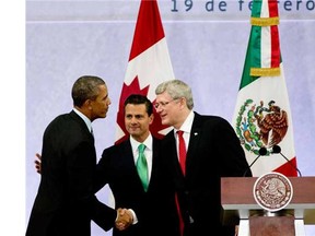 In this file photo, President Barack Obama, left, Mexico's President Enrique Pena Nieto, centre, and the Prime Minister of Canada, Stephen Harper, shake hands at a summit in Mexico this year that highlighted that the economic cooperation that has grown since NAFTA joined the U.S., Canada and Mexico 20 years ago.