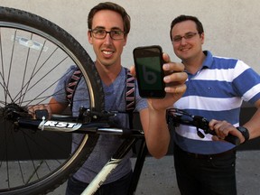 Paolo Piunno, left, co-founder and president of Daedas, and Windsor Coun. Irek Kusmierczyk, director of robotics at WEtech Alliance, with phone app Friday July 11, 2014. (NICK BRANCACCIO/The Windsor Star)