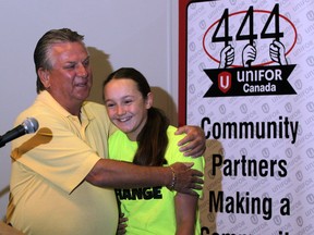 In this file photo, Ken Lewenza, longtime president of CAW Local 444 (now Unifor) and former shop-floor steward at Chrysler's Windsor Assembly Plant hugs Sarah Lewis of Street Help after Lewenza donated $30,000 to three area charities, Monday July 14, 2014. Street Help, Downtown Mission and Pathway to Potential each received a generous cheque from money raised at Lewenza's retirement party. (NICK BRANCACCIO/The Windsor Star)