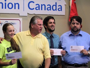 Dino Chiodo, left, Unifor Local 444 president, Sarah Lewis of Street Help, Ken Lewenza, former head of CAW Canada (now Unifor), Adam Vasey of Pathway To Potential and Ron Dunn of Downtown Mission all gather for a group photograph after Lewenza donated a total of $30,000 to the three charities Monday July 14, 2014. (NICK BRANCACCIO/The Windsor Star)