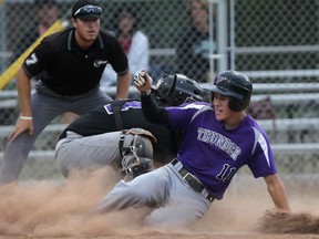 Tecumseh Juniors'  Brandon Gignac, right, slides safely into home after hitting an inside-the-park homer against the Tecumseh Seniors at Lacasse Parl. The play was later reversed after the third base umpire ruled the runner batted in failed to touch third base and was called for the third out. (DAX MELMER/The Windsor Star)