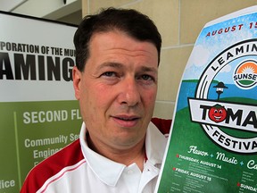 Mike Ciacelli is chair of the Leamington Sunset Tomato Festival.  Cicacelli poses with this year's festival poster at town hall July 23, 2014.  (NICK BRANCACCIO/The Windsor Star)