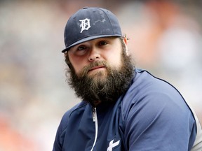 Tigers relief pitcher Joba Chamberlain sits on the dugout railing before a game against the Tampa Bay Rays in Detroit. (AP Photo/Carlos Osorio)