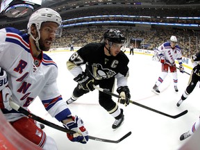 Windsor native Dominic Moore, left, checks Sidney Crosby of the Penguins in Game 1 of the Stanley Cup playoffs at Consol Energy Center. (Photo by Justin K. Aller/Getty Images)