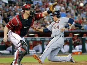 Detroit's Miguel Cabrera, right, scores on a sacrifice fly by teammate Alex Avila as Arizona catcher Miguel Montero makes the catch during the fourth inning Wednesday in Phoenix. (AP Photo/Matt York)