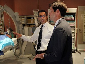 Ontario Minister of Health and Long-Term Care Dr. Eric Hoskins, rights, visits Windsor Regional Hospital's Ouellette Avenue Campus cath lab with Dr. Roland Mihail, chief of cardiology. f]Funding for a new 24 hour two-table cardiac catheterization lab was announced Friday July 25, 2014. (NICK BRANCACCIO/The Windsor Star)