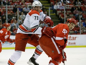 Windsor's Brett Bellemore, left, is checked by Detroit's  Jonathan Ericsson. (AP Photo/Carlos Osorio)